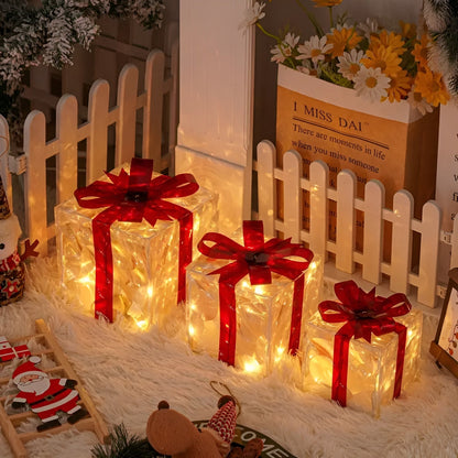 Close-up van een transparante cadeaudoos met rood lint