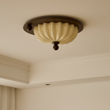 Onderzijde van de plafondlamp met glazen kap en houtlook rand