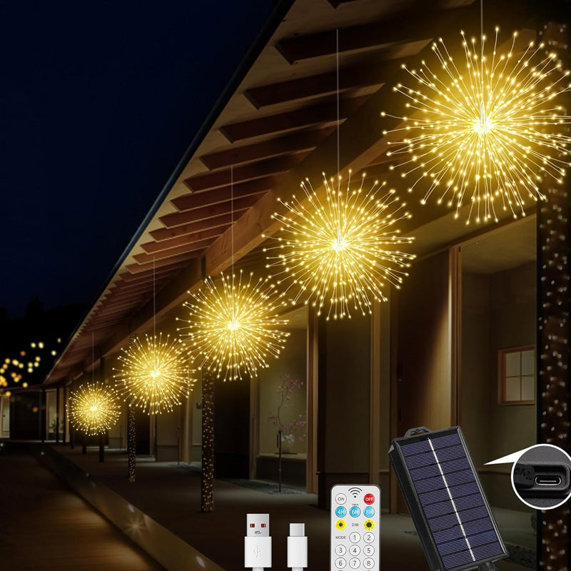 tuinverlichting met vuurwerkeffect verlicht een border bij nacht
