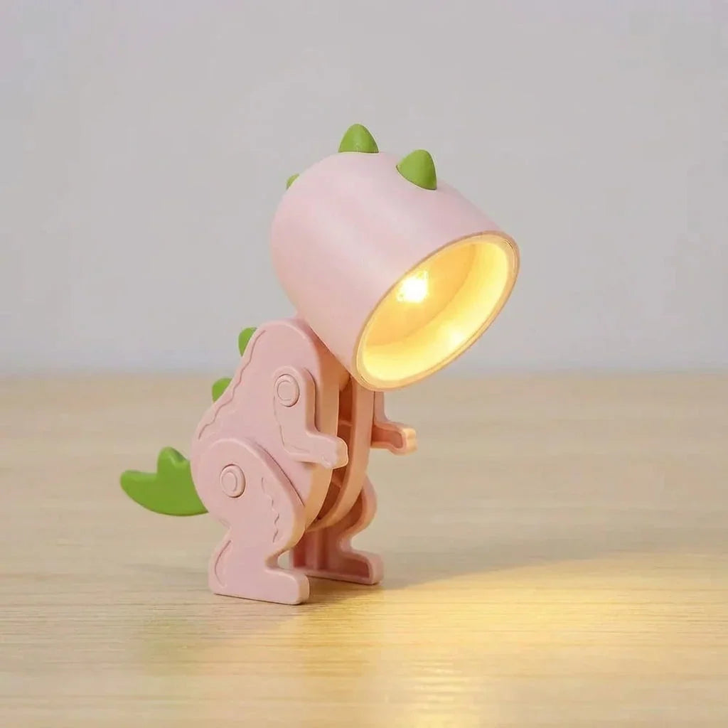 kinderbureaulamp in dinosaurusvorm bevestigd aan de rand van een bureau